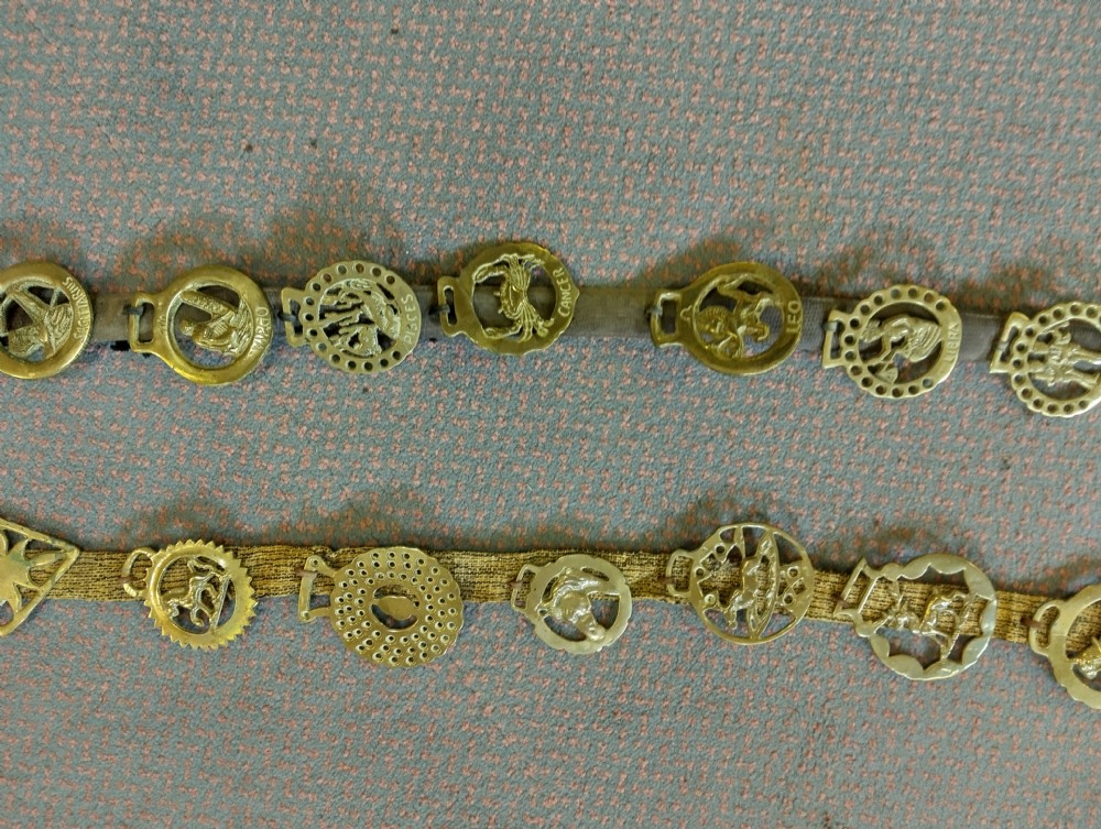 Two vertical leather martingale straps mounted with twenty-two brass horse brasses, including a complete set featuring astrological Zodiac symbols. View III