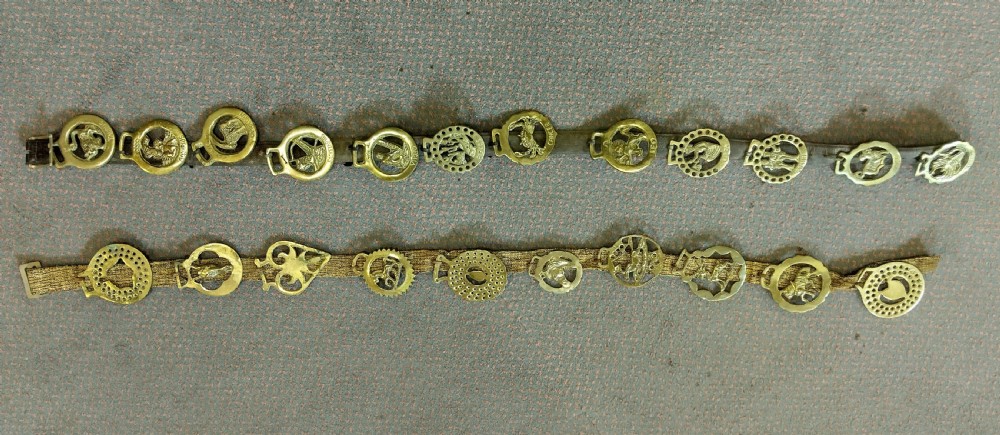 Two vertical leather martingale straps mounted with twenty-two brass horse brasses, including a complete set featuring astrological Zodiac symbols. View IV