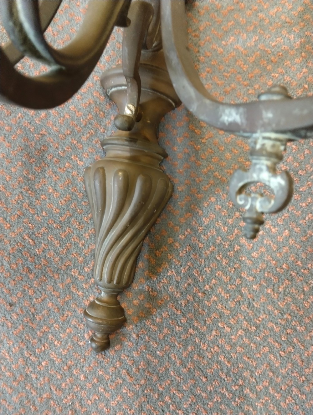A pair of patinated three-arm solid brass wall sconces featuring fluted urn-shaped backplates and curved candle branches. View II