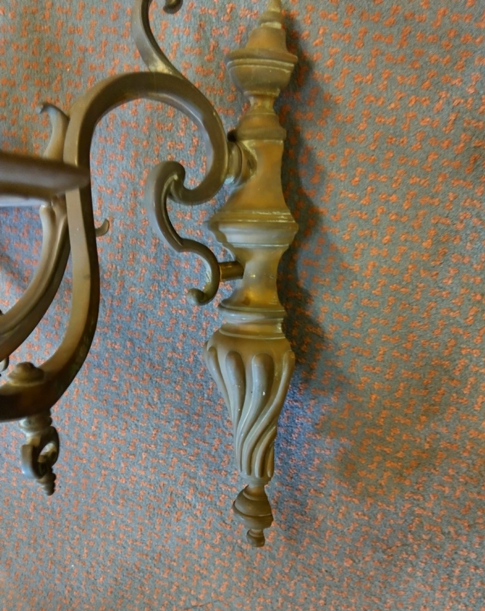 A pair of patinated three-arm solid brass wall sconces featuring fluted urn-shaped backplates and curved candle branches. View IV
