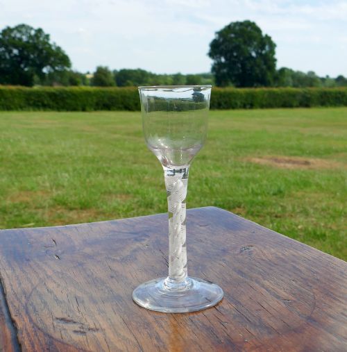 ANTIQUE EARLY 18THC OPAQUE TWIST WINE GLASS WITH OGEE BOWL AND CONICAL FOOT ENGLISH C176070