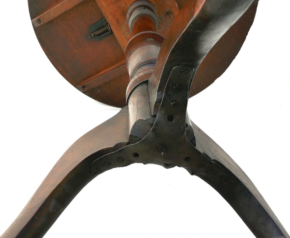 An 18th-century oak tilt-top tripod table featuring a circular top on a turned pedestal and three arched legs. View IV