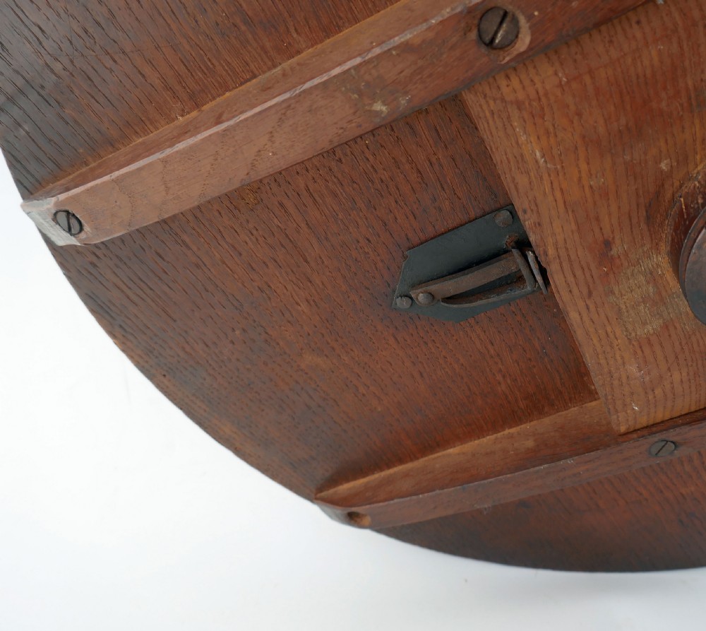 An 18th-century oak tilt-top tripod table featuring a circular top on a turned pedestal and three arched legs. View VI