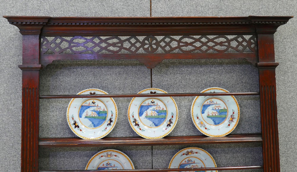 An 18th-century dark oak and pine delft rack featuring pierced fretwork at the top and fluted columns along the sides. View II