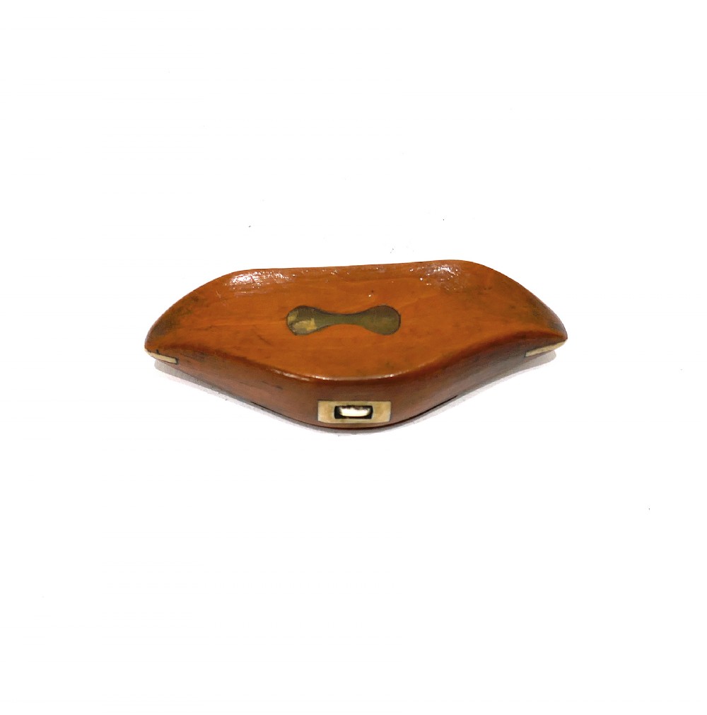 A boat-shaped fruitwood shuttle snuff box featuring decorative bone inlay on the hinged lid and front catch mechanism. View II