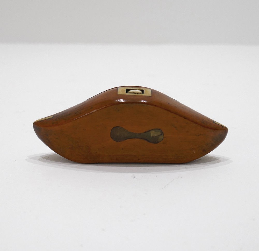 A boat-shaped fruitwood shuttle snuff box featuring decorative bone inlay on the hinged lid and front catch mechanism. View IV