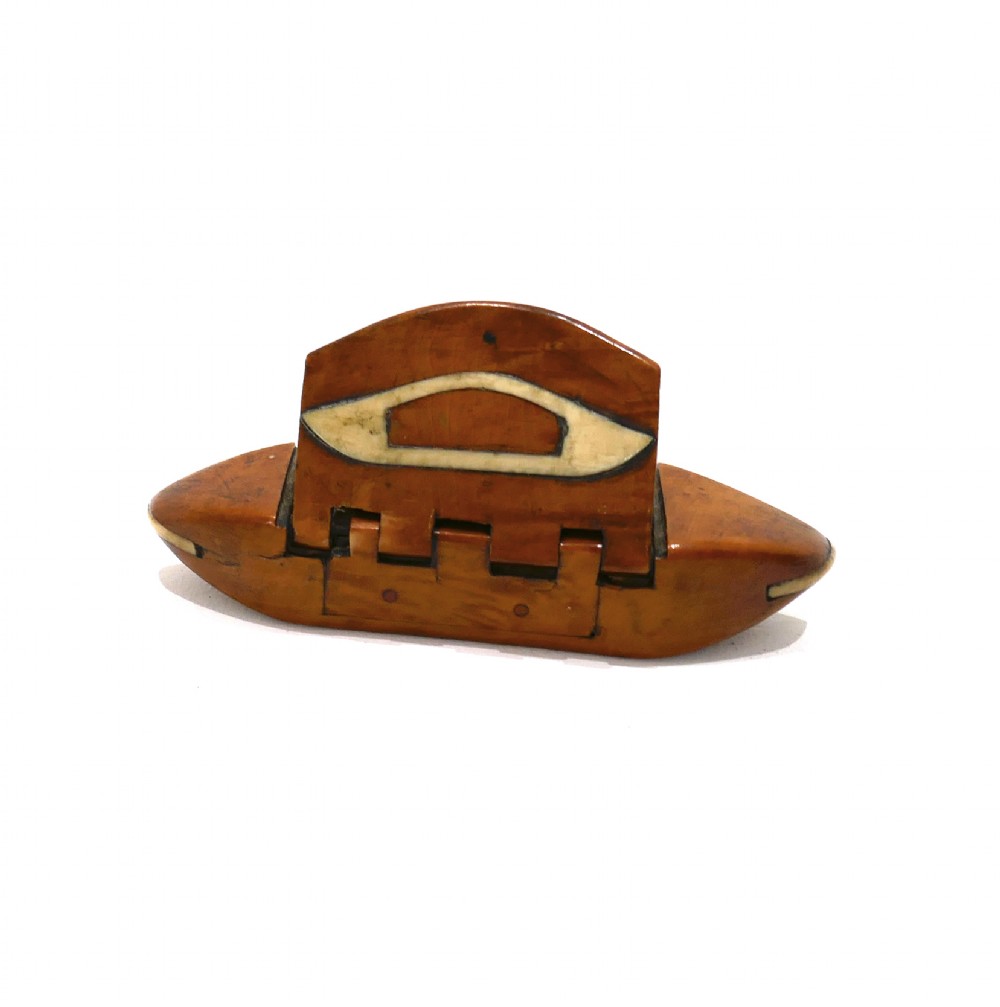 A boat-shaped fruitwood shuttle snuff box featuring decorative bone inlay on the hinged lid and front catch mechanism. View V