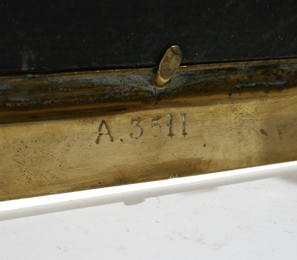 A late 19th-century Victorian double brass picture frame with ornate engraved geometric borders and classical mask finials. View IV
