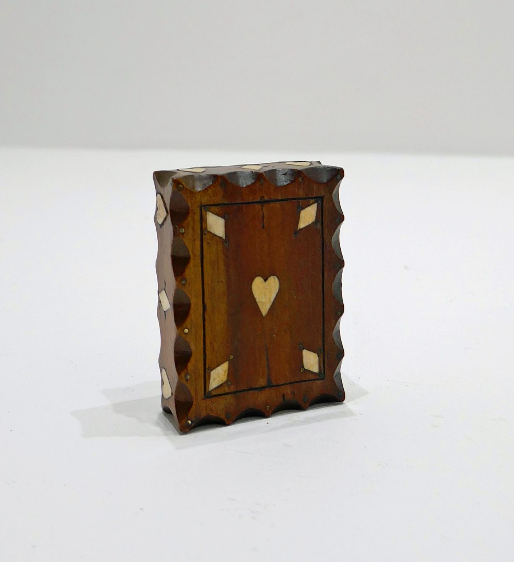 An antique nineteenth-century rectangular fruitwood snuff box featuring scalloped carved borders and inlaid bone heart and diamond shapes. View II