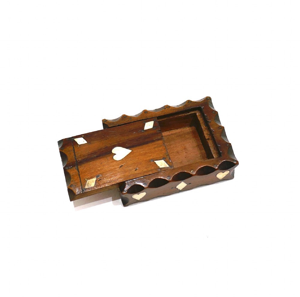An antique nineteenth-century rectangular fruitwood snuff box featuring scalloped carved borders and inlaid bone heart and diamond shapes. View III