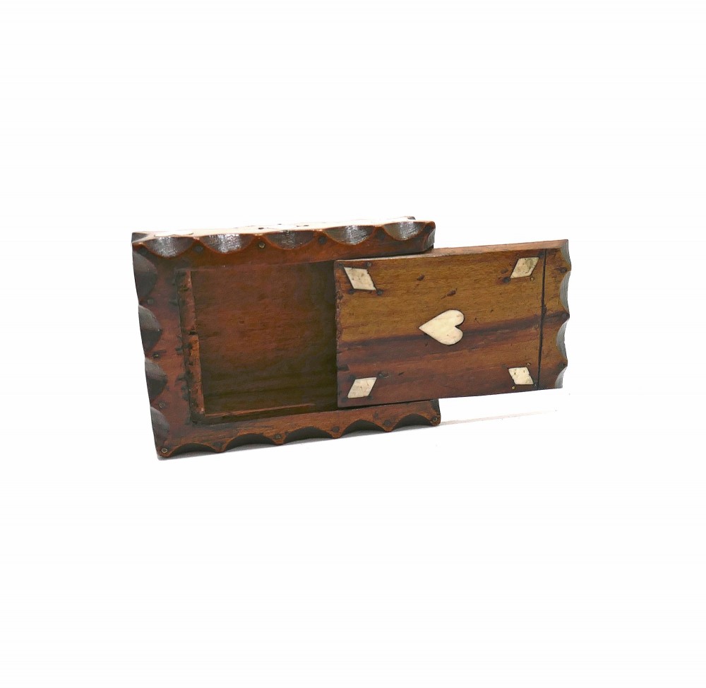 An antique nineteenth-century rectangular fruitwood snuff box featuring scalloped carved borders and inlaid bone heart and diamond shapes. View V