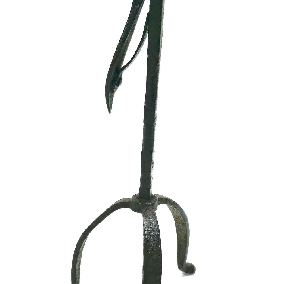 An eighteenth-century hand-forged wrought iron rushlight holder with a spring-action clamp and a tripod base. View V