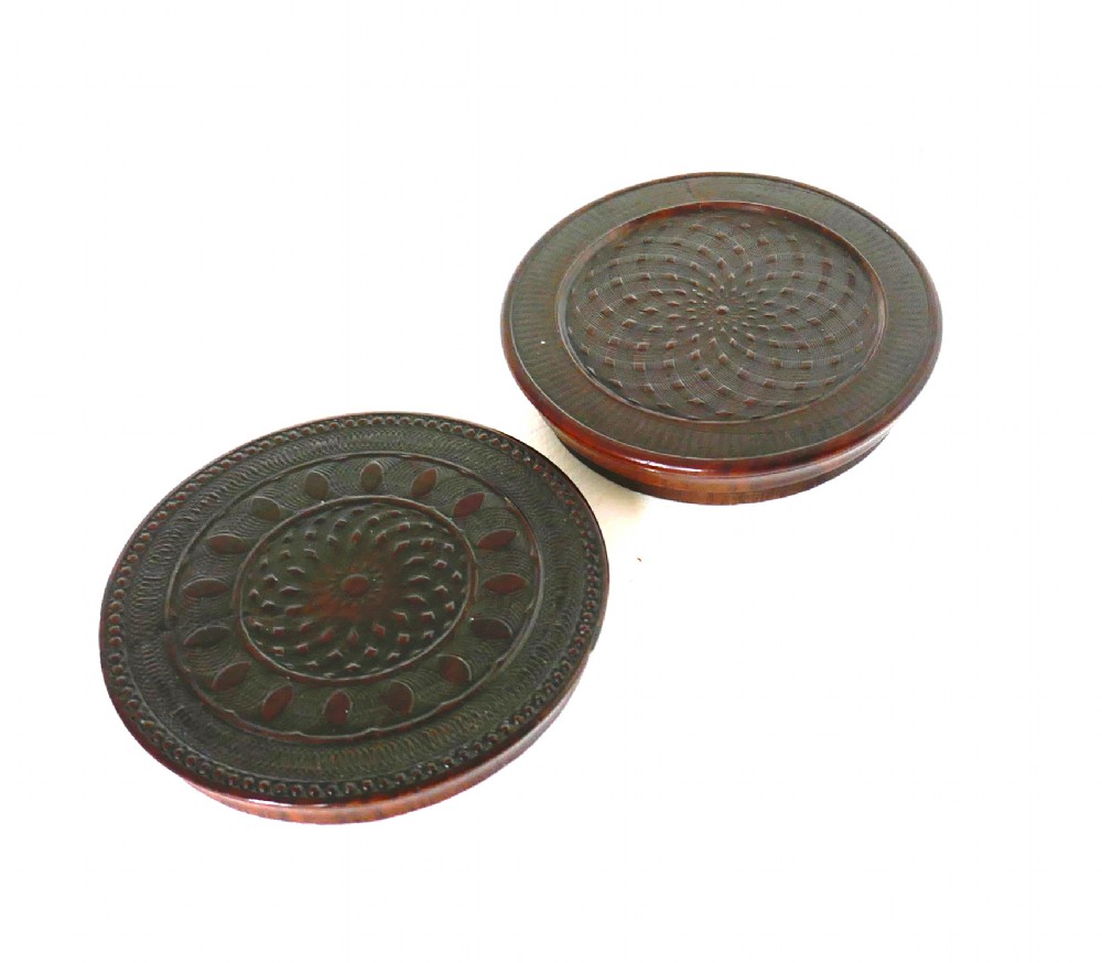 A circular early 19th-century dark laburnum wood snuff box featuring engine-turned geometric pattern carving on the lid. View IV