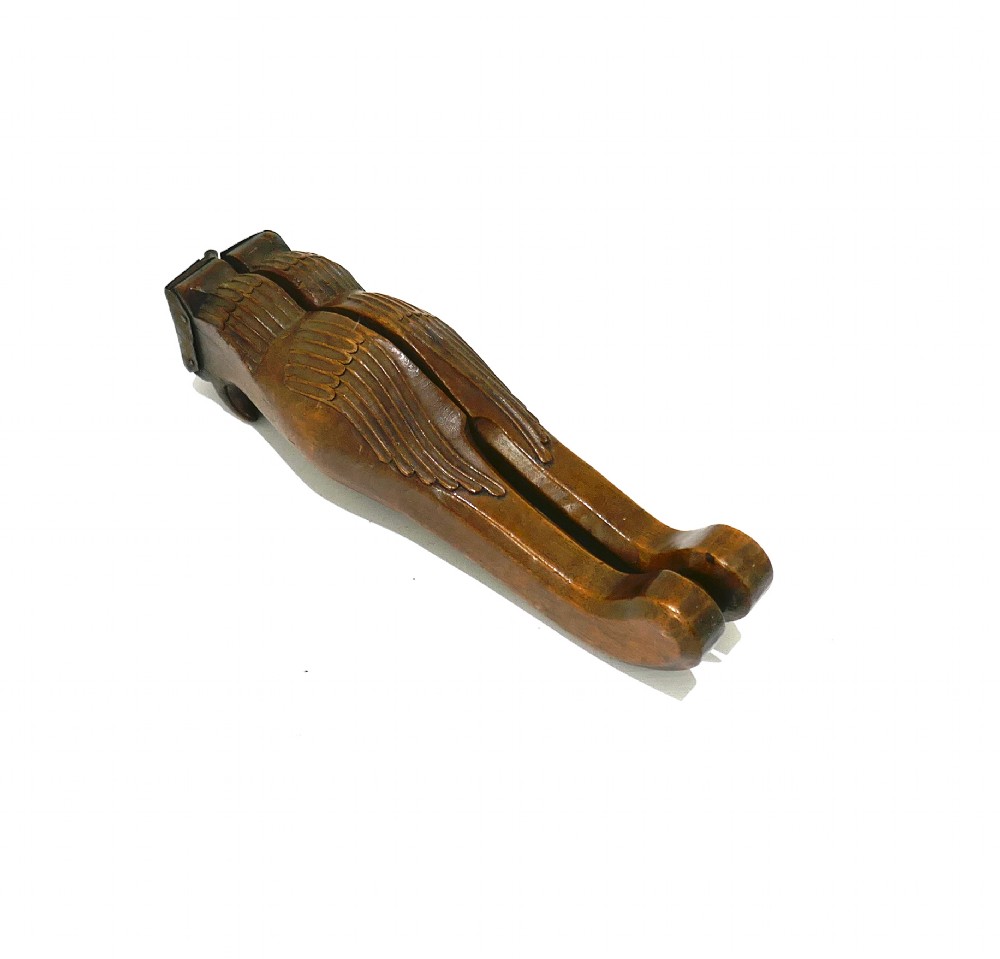 A 19th-century carved sycamore lemon squeezer shaped as two falcon heads with a hinged top and dark wood patina. View V
