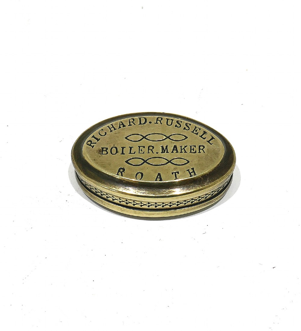An oval antique brass snuff box with engraved lettering reading Richard Russell Boiler Maker Roath. View II