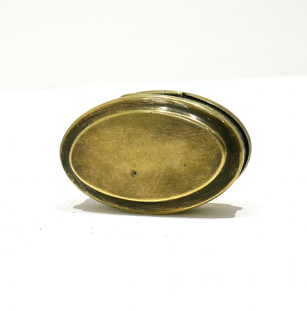 An oval antique brass snuff box with engraved lettering reading Richard Russell Boiler Maker Roath. View IV