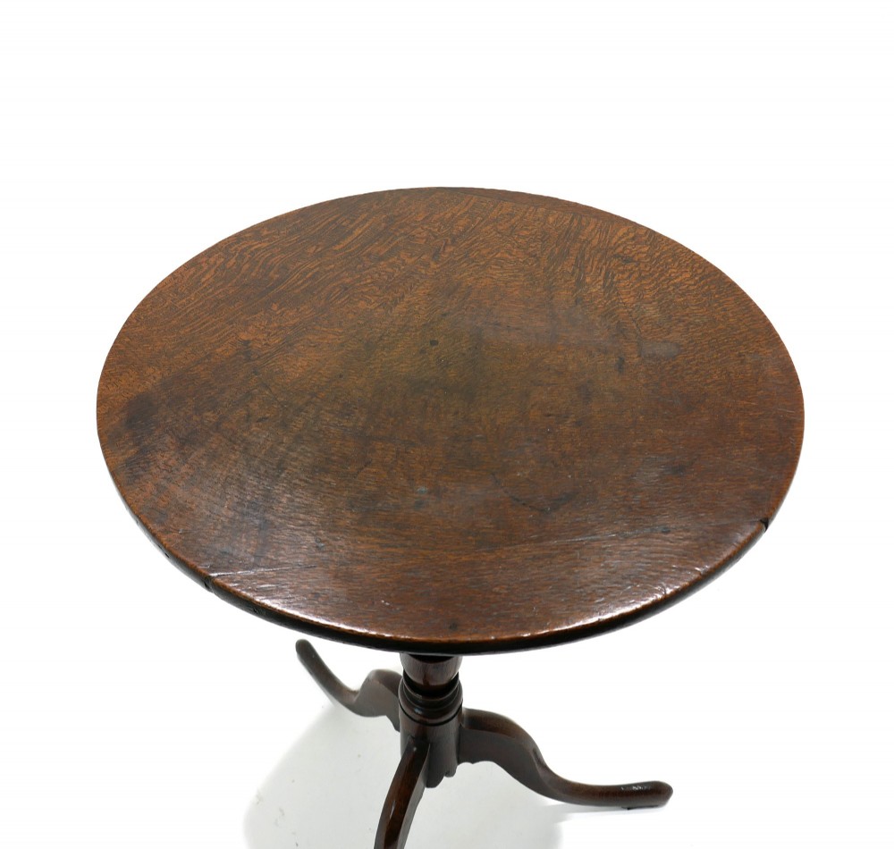 An 18th-century dark oak tripod table featuring a circular top, a slender turned central column stem, and three curved splayed legs. View II