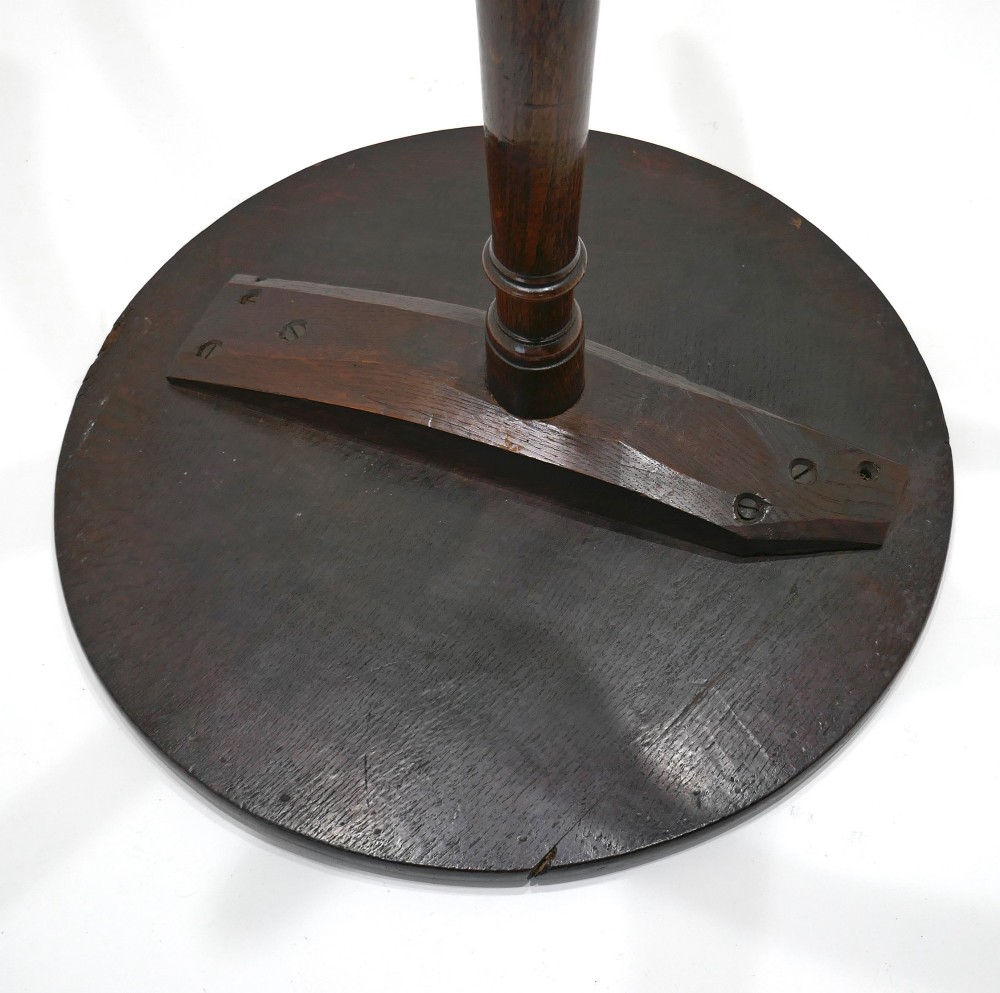 An 18th-century dark oak tripod table featuring a circular top, a slender turned central column stem, and three curved splayed legs. View IV