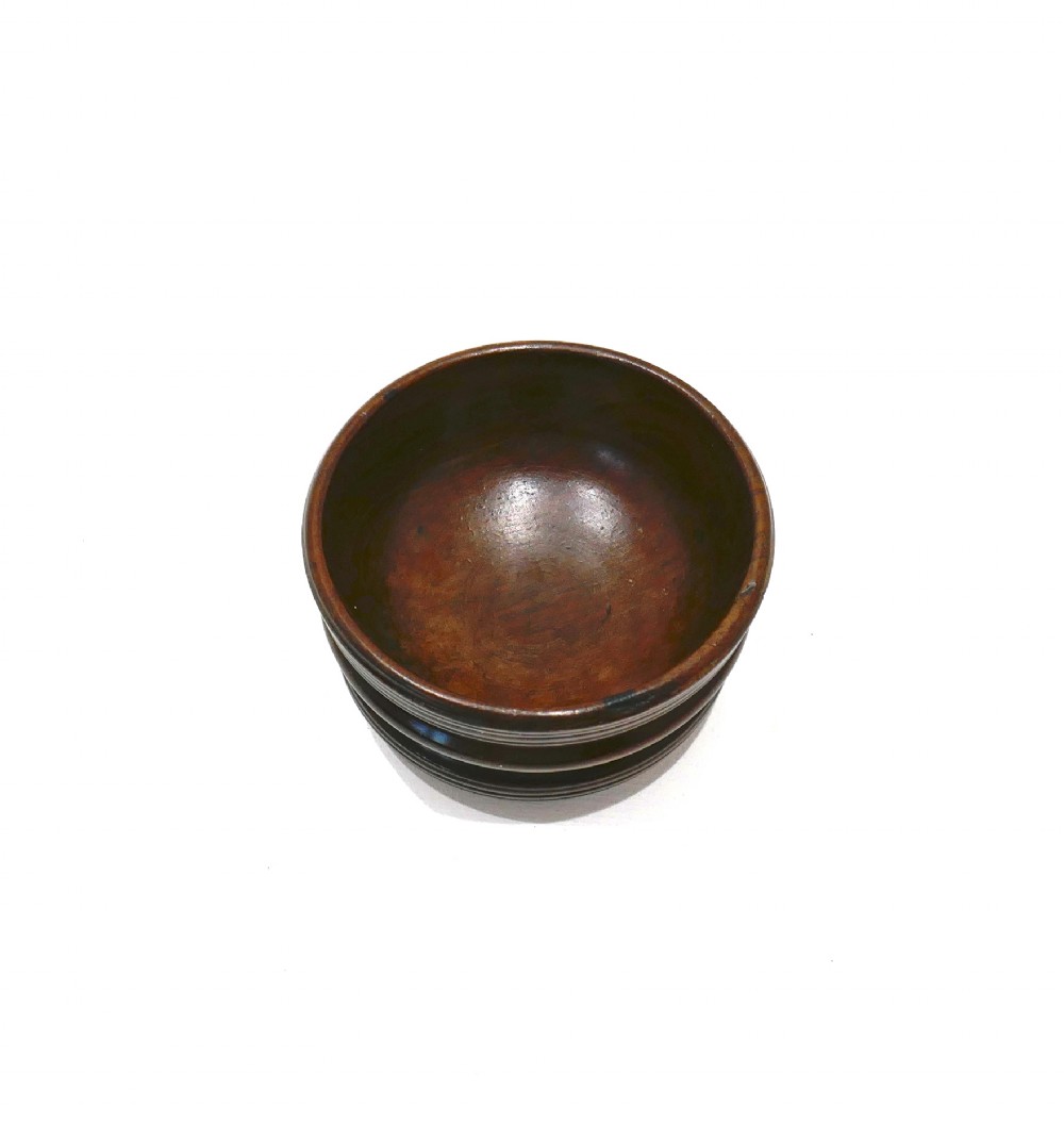 An antique late 18th-century turned laburnum wood open salt cellar featuring a ribbed exterior and a rich dark brown polished finish. View II