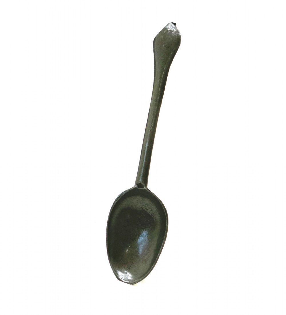 An eighteenth-century English pewter dognose spoon featuring an elongated oval bowl and an oxidised grey finish.