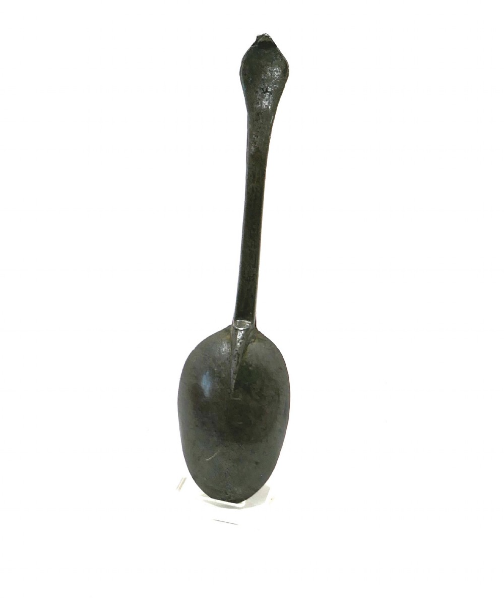 An eighteenth-century English pewter dognose spoon featuring an elongated oval bowl and an oxidised grey finish. View V