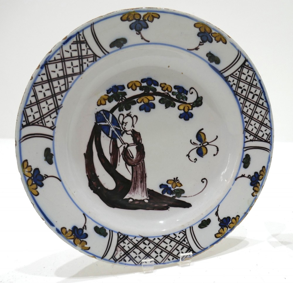 A pair of 18th-century circular tin-glazed earthenware plates decorated with hand-painted polychrome chinoiserie figures and floral rim borders. View III