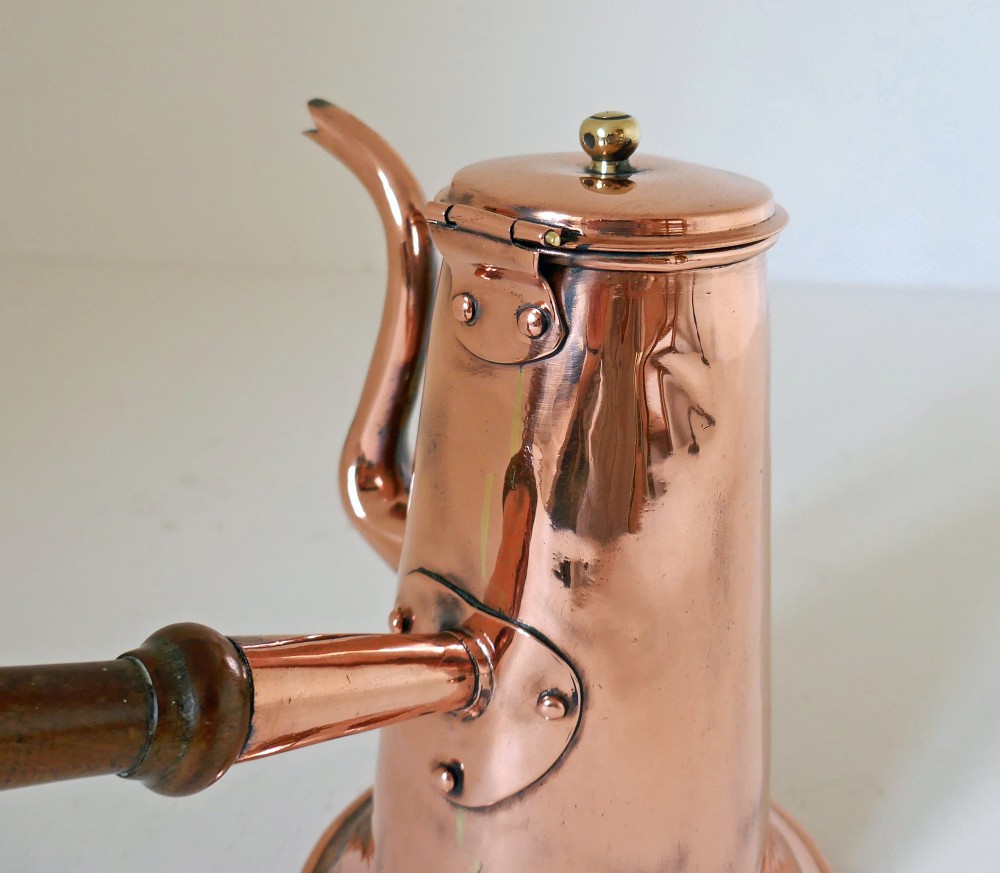 A Georgian copper coffee pot featuring a tapered body, flared base, swan-neck spout, hinged lid with brass finial, and a turned wooden side handle. View III