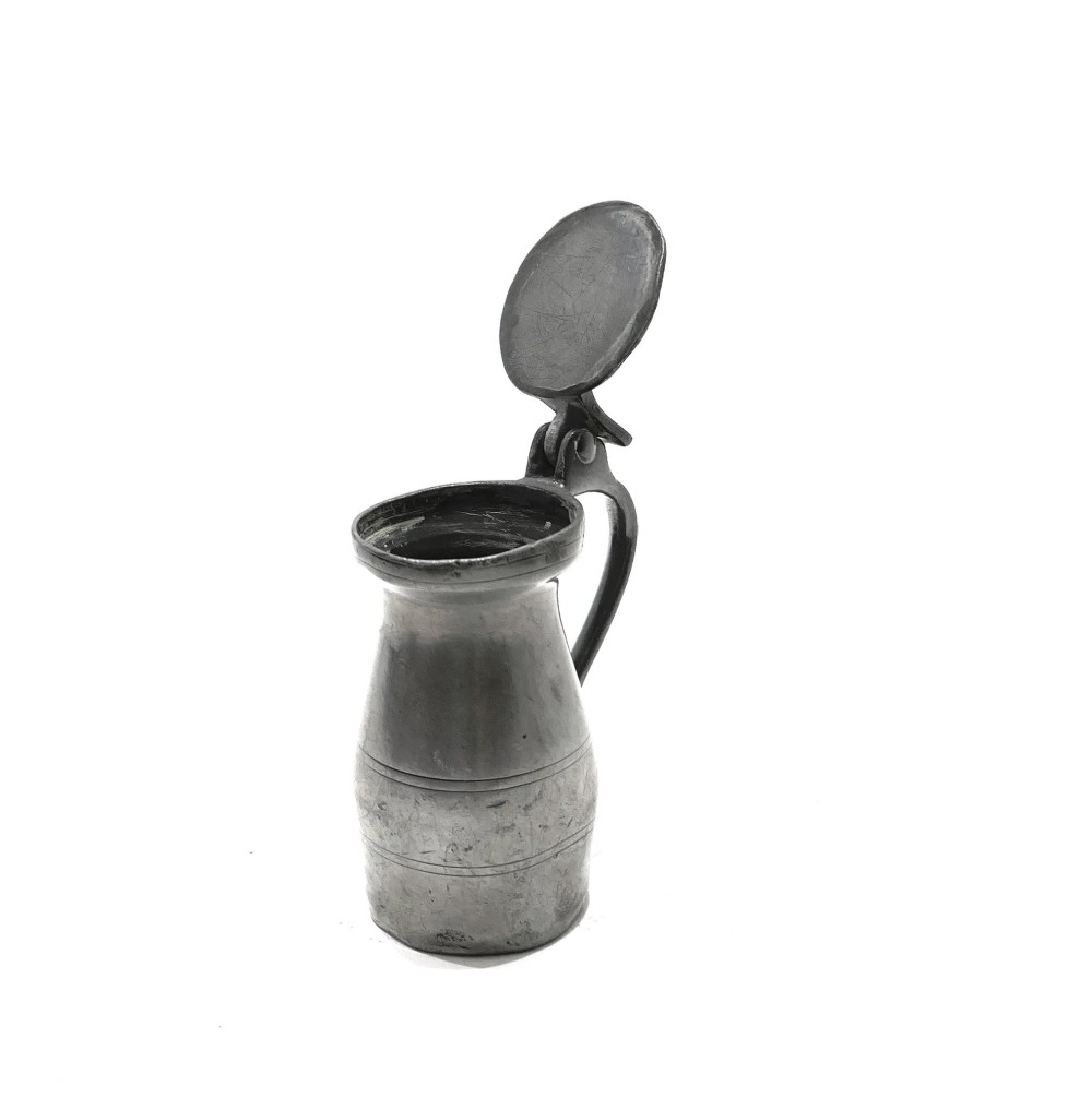 An 18th-century English pewter spirit measure featuring a flat hinged lid, curved handle, and incised horizontal lines around a baluster body. View III