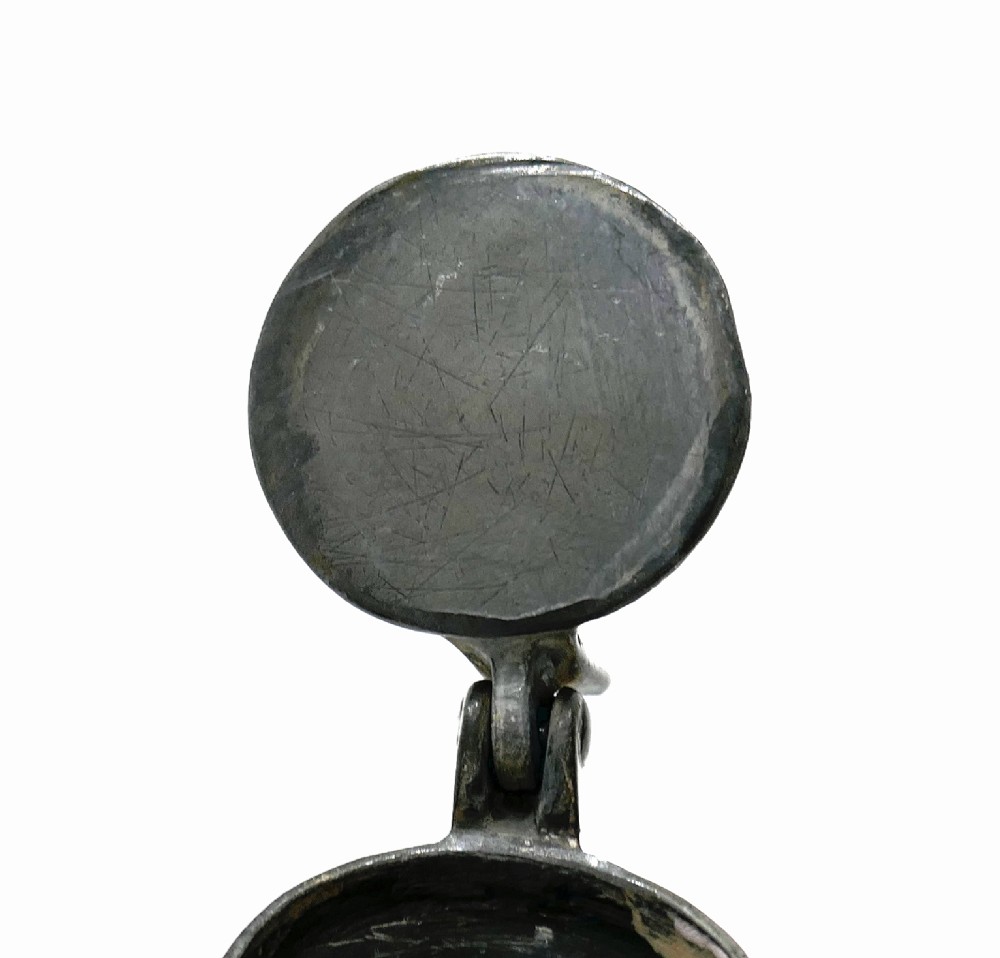 An 18th-century English pewter spirit measure featuring a flat hinged lid, curved handle, and incised horizontal lines around a baluster body. View IV