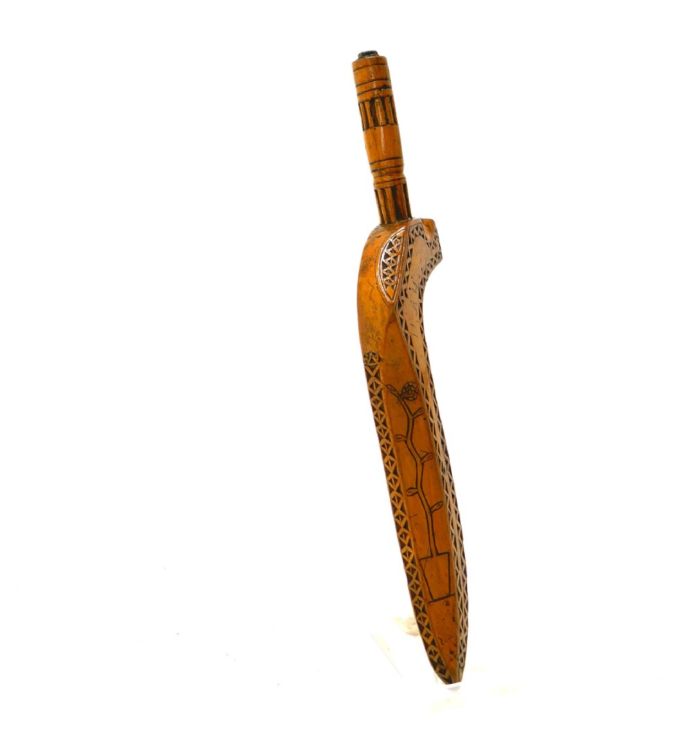 A 19th-century Cumbrian fruitwood goosewing knitting sheath featuring intricate chip-carved and punchwork geometric decoration alongside a turned terminal. View II