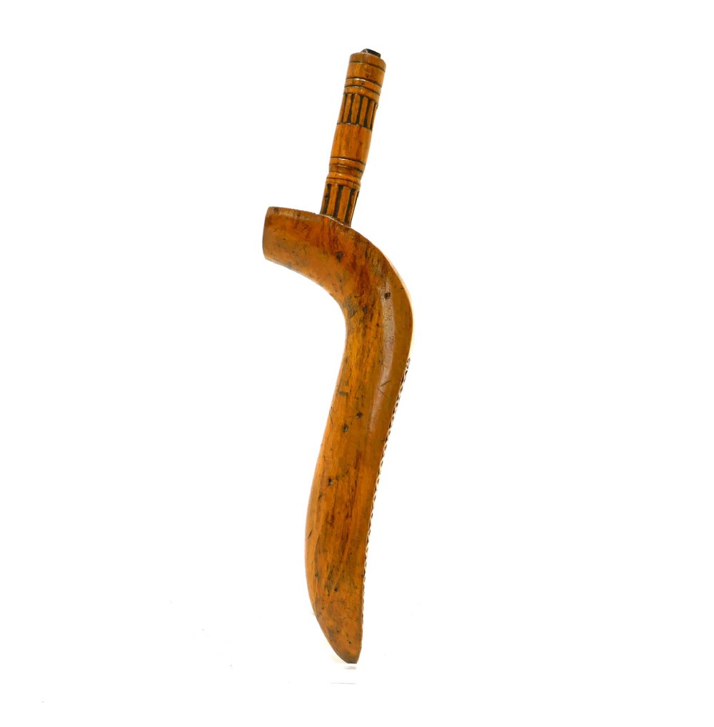 A 19th-century Cumbrian fruitwood goosewing knitting sheath featuring intricate chip-carved and punchwork geometric decoration alongside a turned terminal. View III