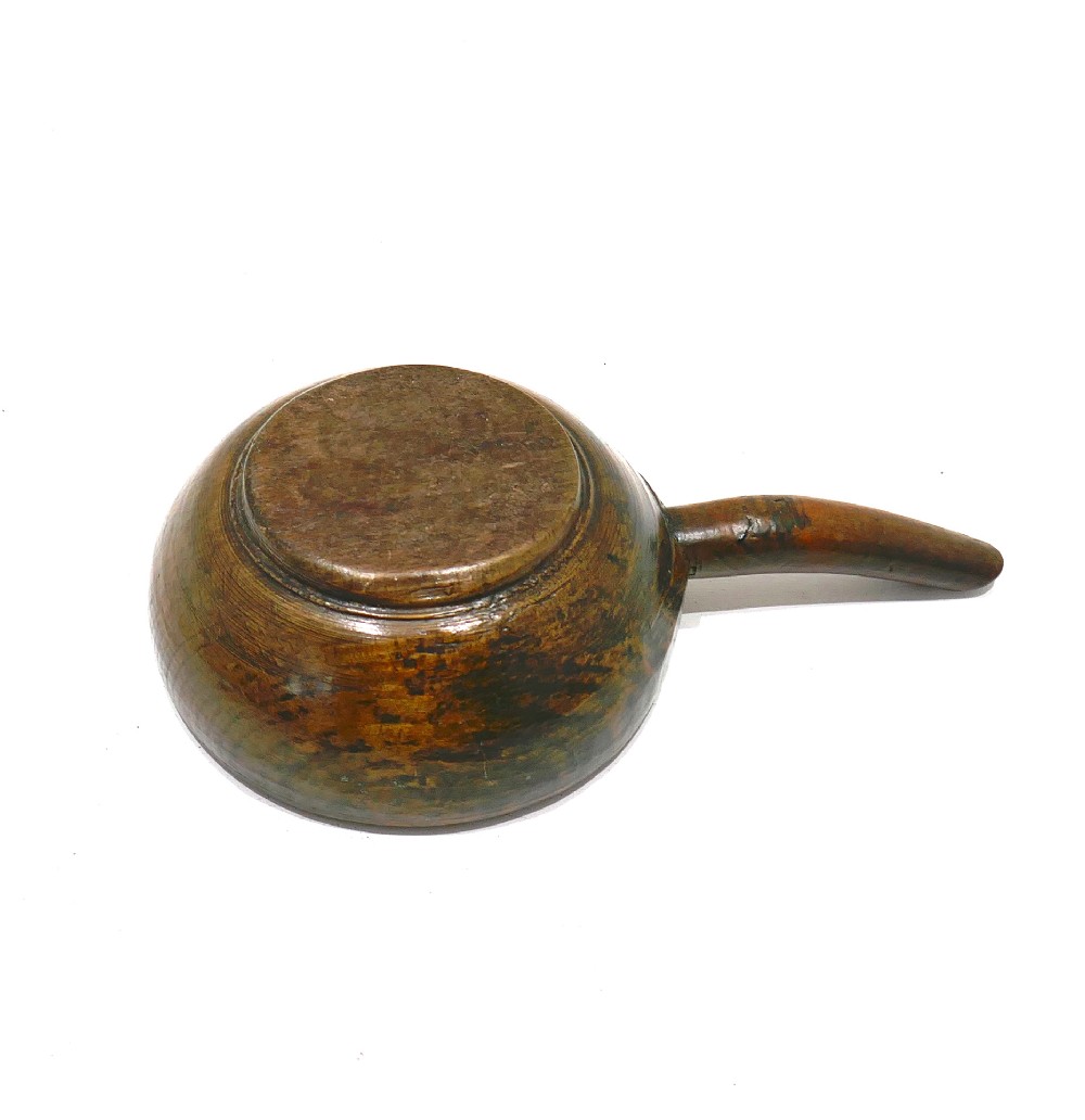 A turned 19th-century dark beechwood dairy bowl with a carved lateral handle and a shallow dished basin. View II