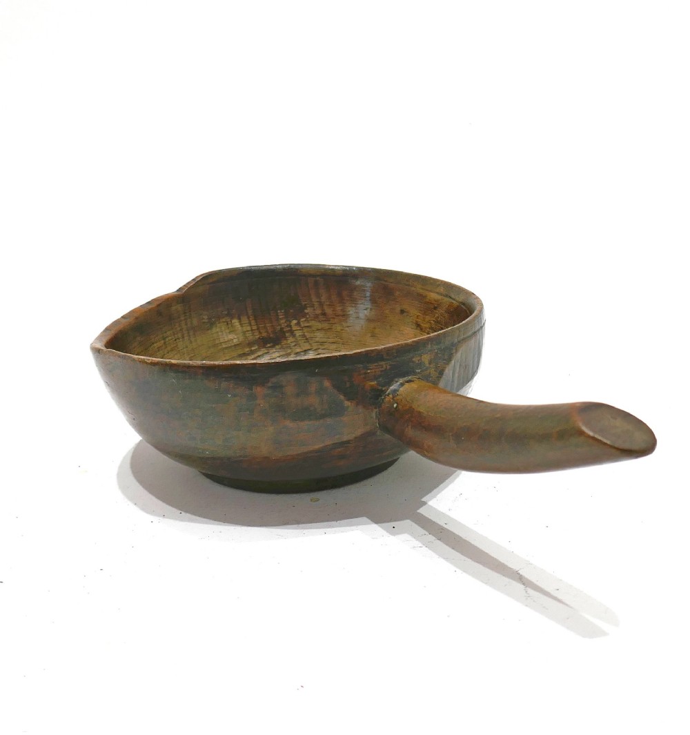 A turned 19th-century dark beechwood dairy bowl with a carved lateral handle and a shallow dished basin. View III