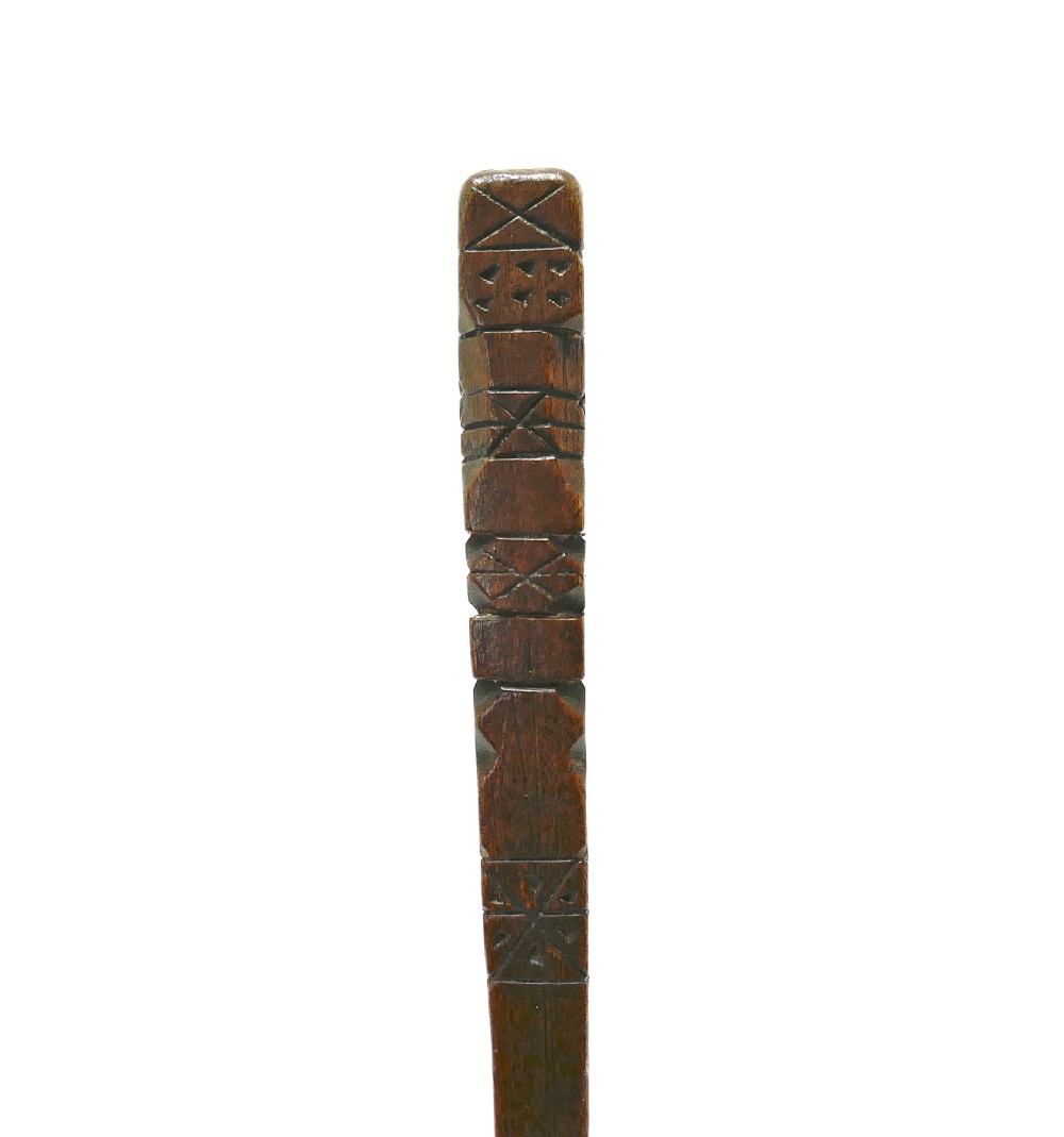 A slender nineteenth-century carved fruitwood knitting sheath featuring geometric incised lines and punchwork decoration. View V