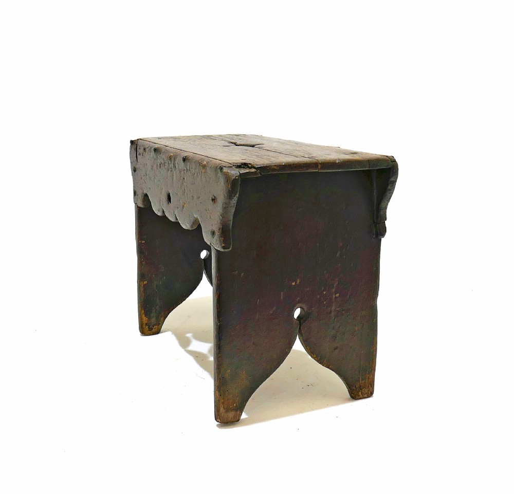 A 19th-century dark pine Scottish creepie stool featuring scalloped aprons and cut-out slab legs. View II