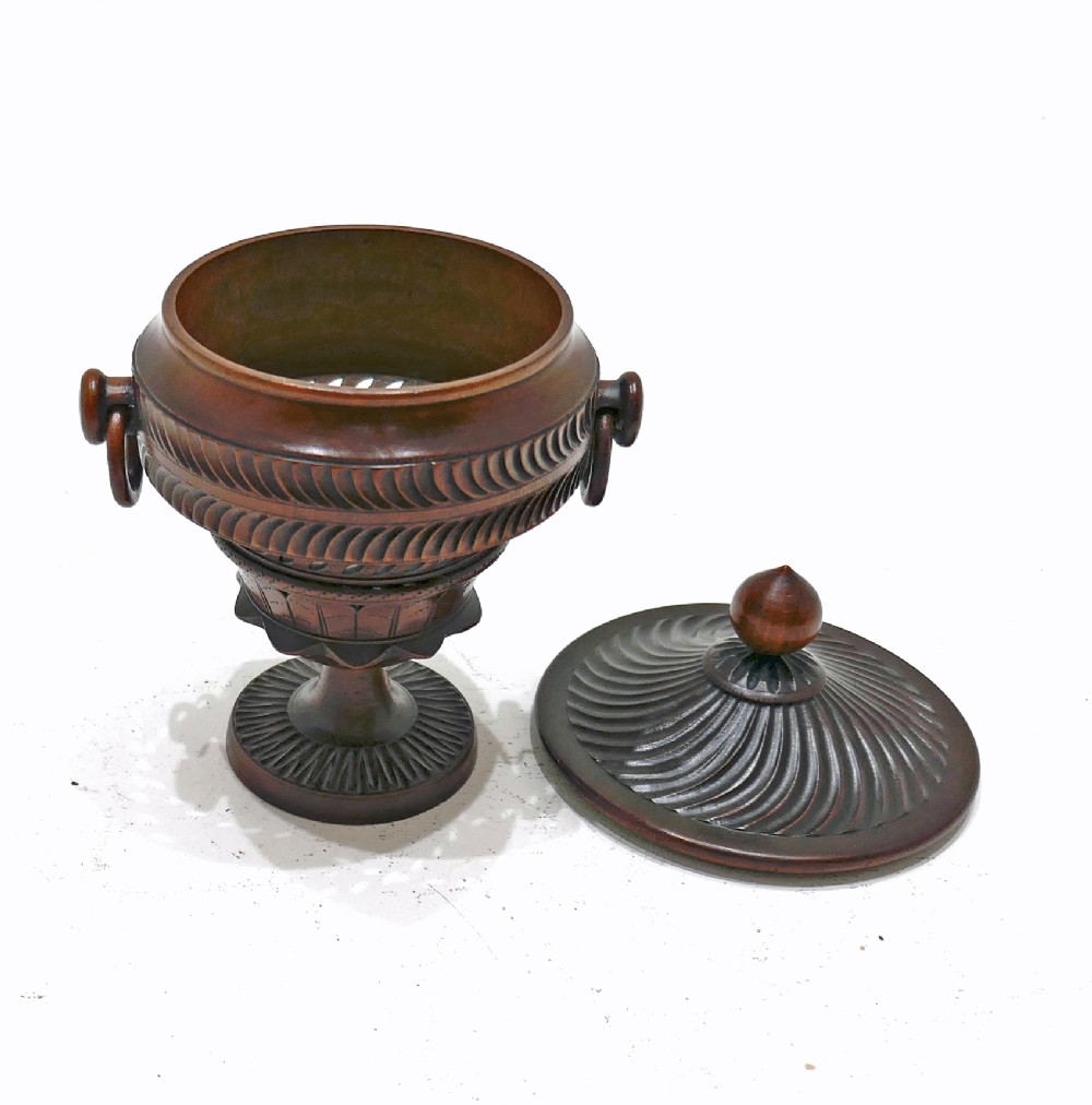 An early 19th-century turned fruitwood lidded pomander cup featuring a finial top, spiralled fluting, carved ring handles, and a pedestal base. View IV