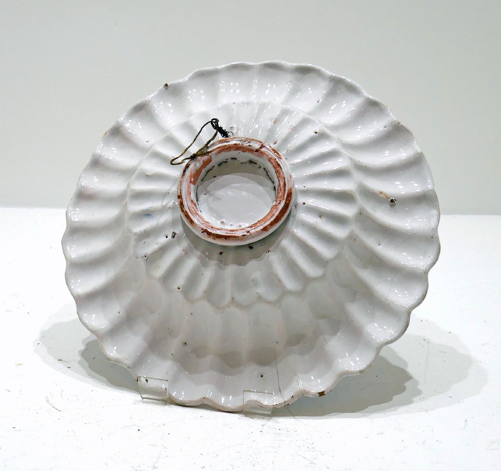 A 17th-century Dutch Delftware lobed ceramic dish featuring a central tulip motif surrounded by blue and yellow hand-painted patterns on an off-white background. View III