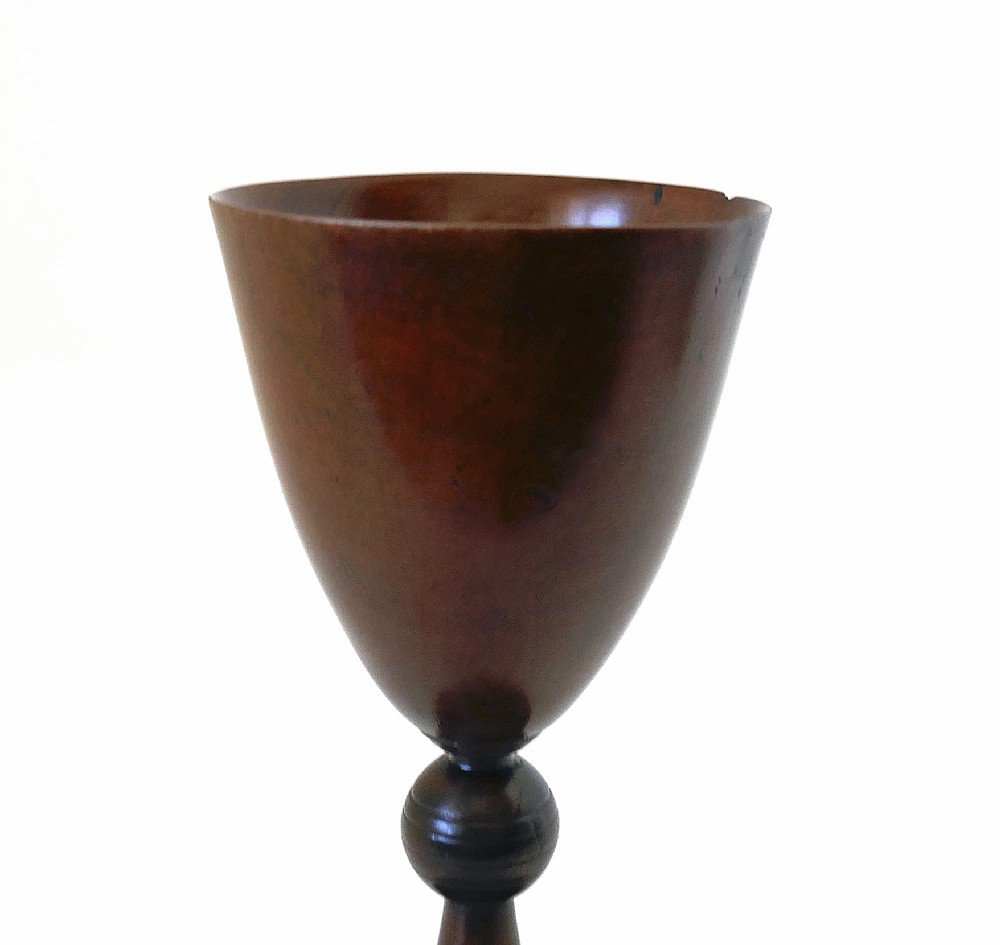 A hand-turned early 19th-century fruitwood goblet featuring a flared bowl, knopped stem, and circular pedestal base with a dark polished patina. View III