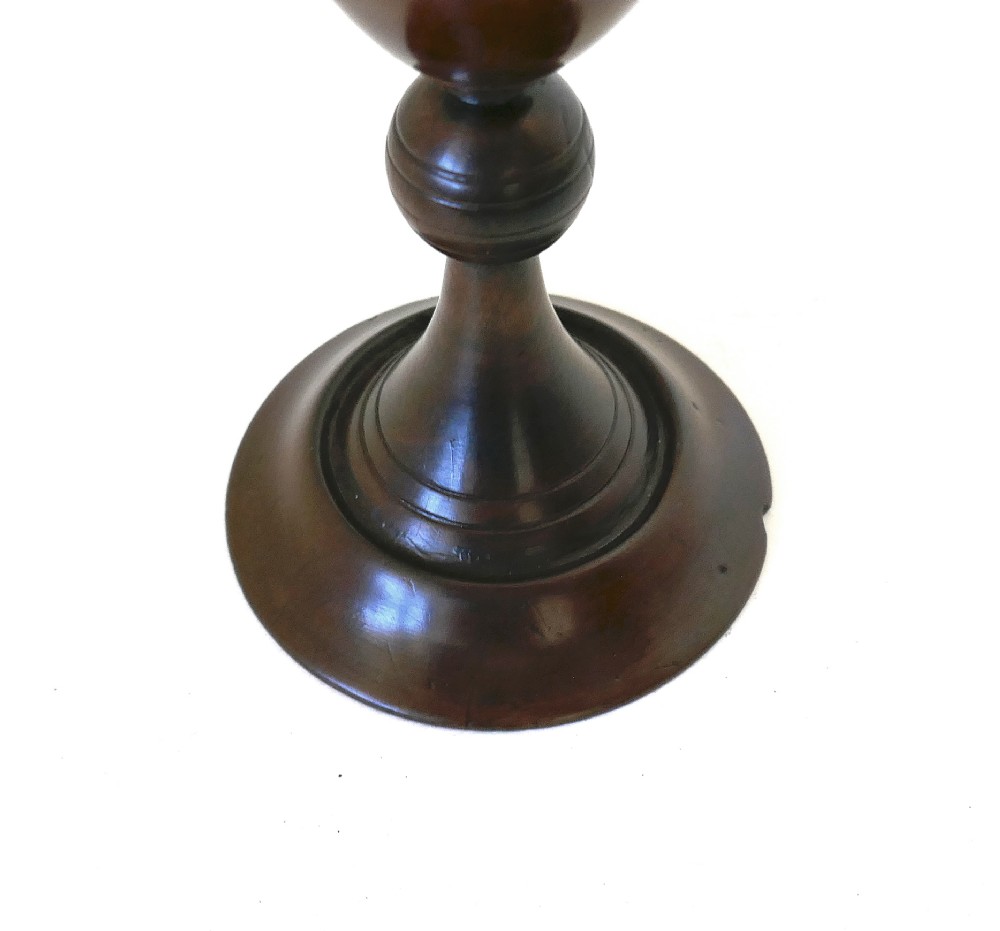 A hand-turned early 19th-century fruitwood goblet featuring a flared bowl, knopped stem, and circular pedestal base with a dark polished patina. View V