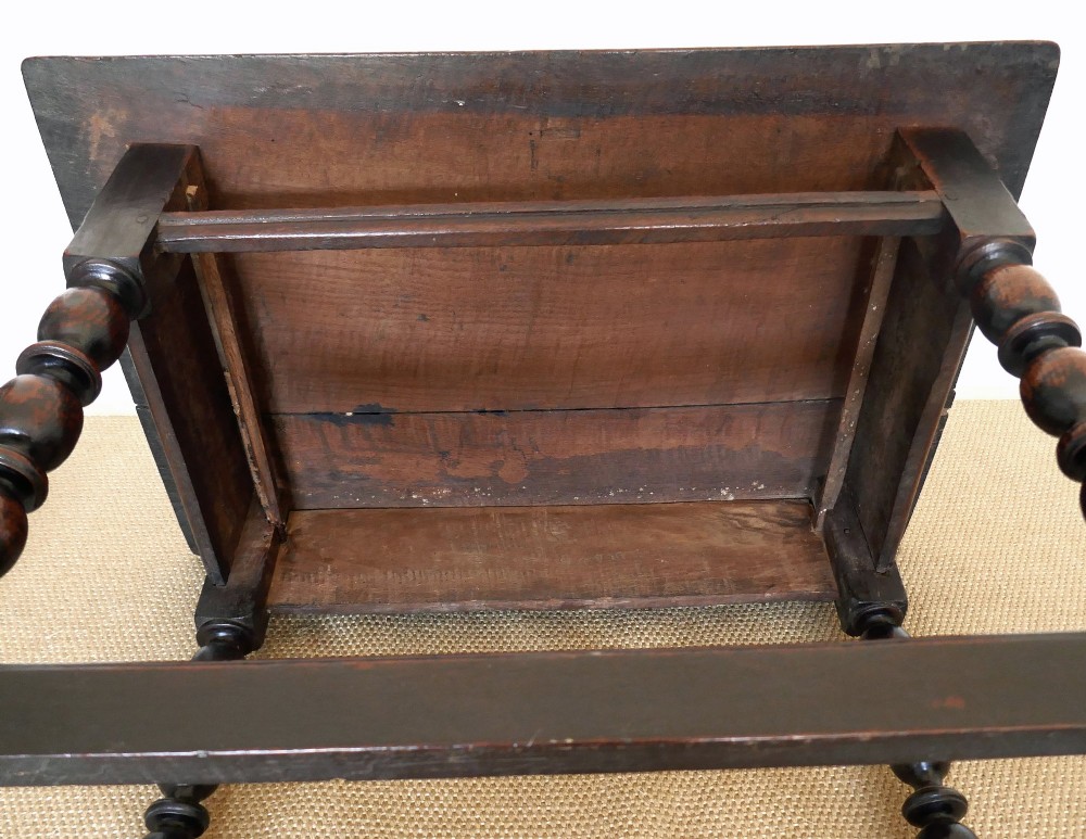 A 17th-century English oak side table featuring a single drawer with brass drop handles, turned ball legs, and a perimeter stretcher base. View VI