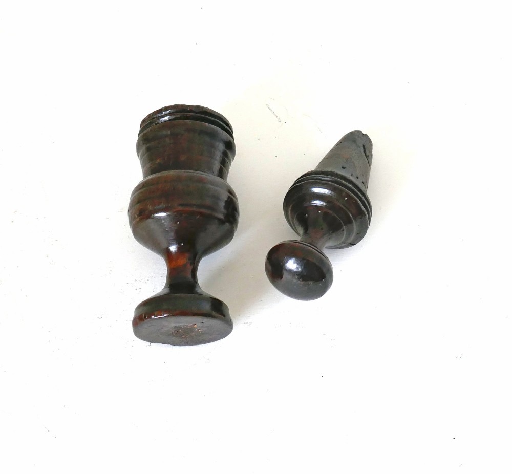 A turned dark sycamore wood two-part spice grinder featuring a baluster-shaped body, ribbed tiering, and a round finial top. View III