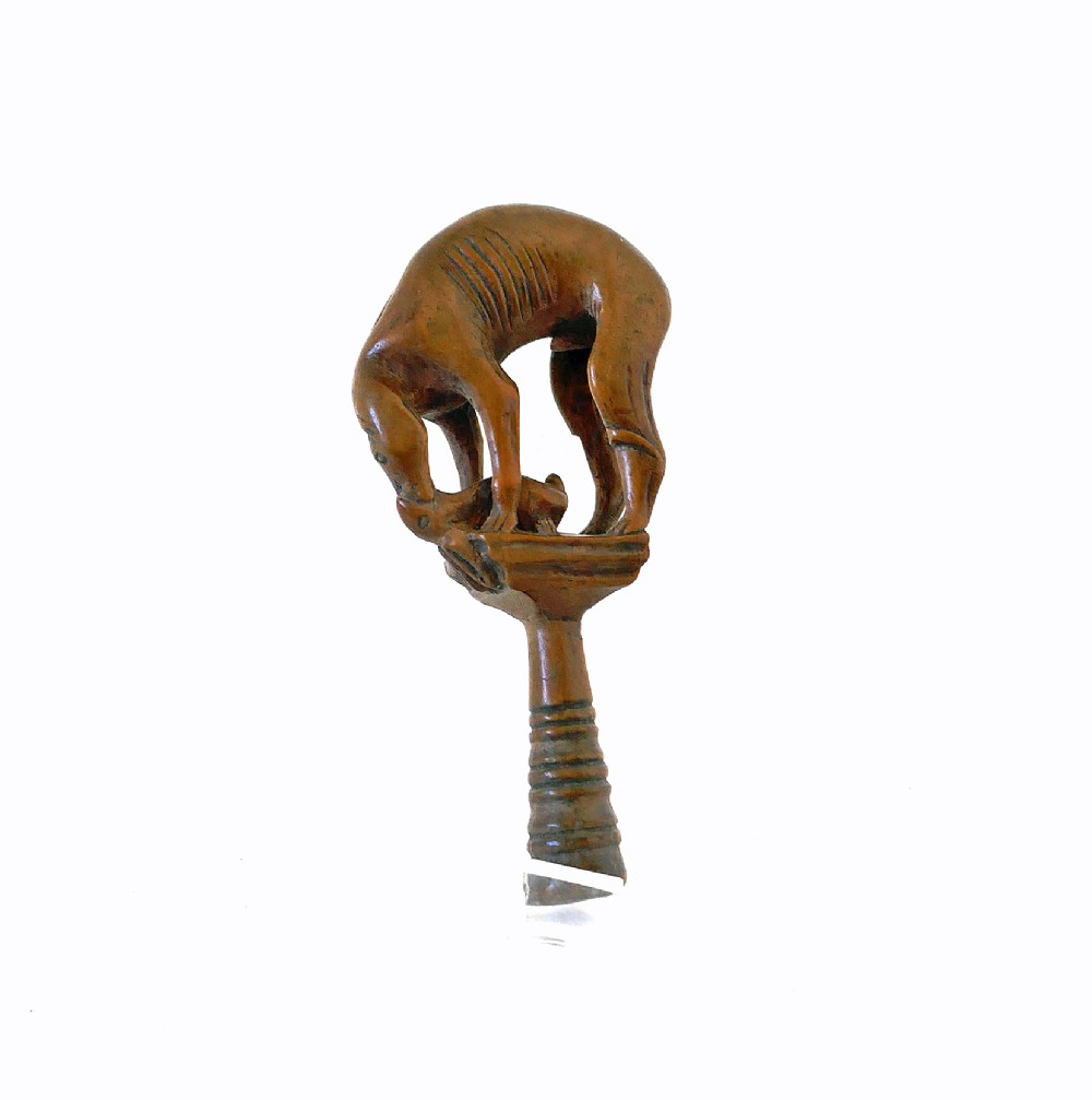 An eighteenth-century boxwood pipe tamper hand-carved in the shape of a greyhound atop a turned pedestal. View II