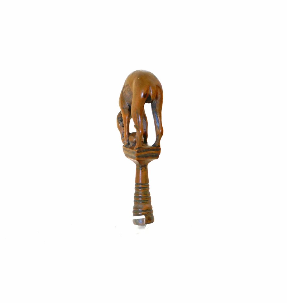 An eighteenth-century boxwood pipe tamper hand-carved in the shape of a greyhound atop a turned pedestal. View III