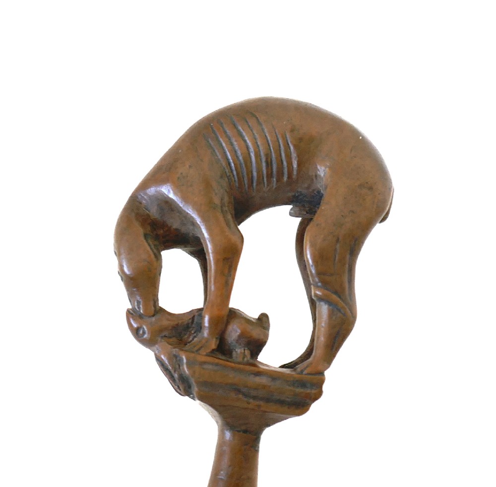 An eighteenth-century boxwood pipe tamper hand-carved in the shape of a greyhound atop a turned pedestal. View IV
