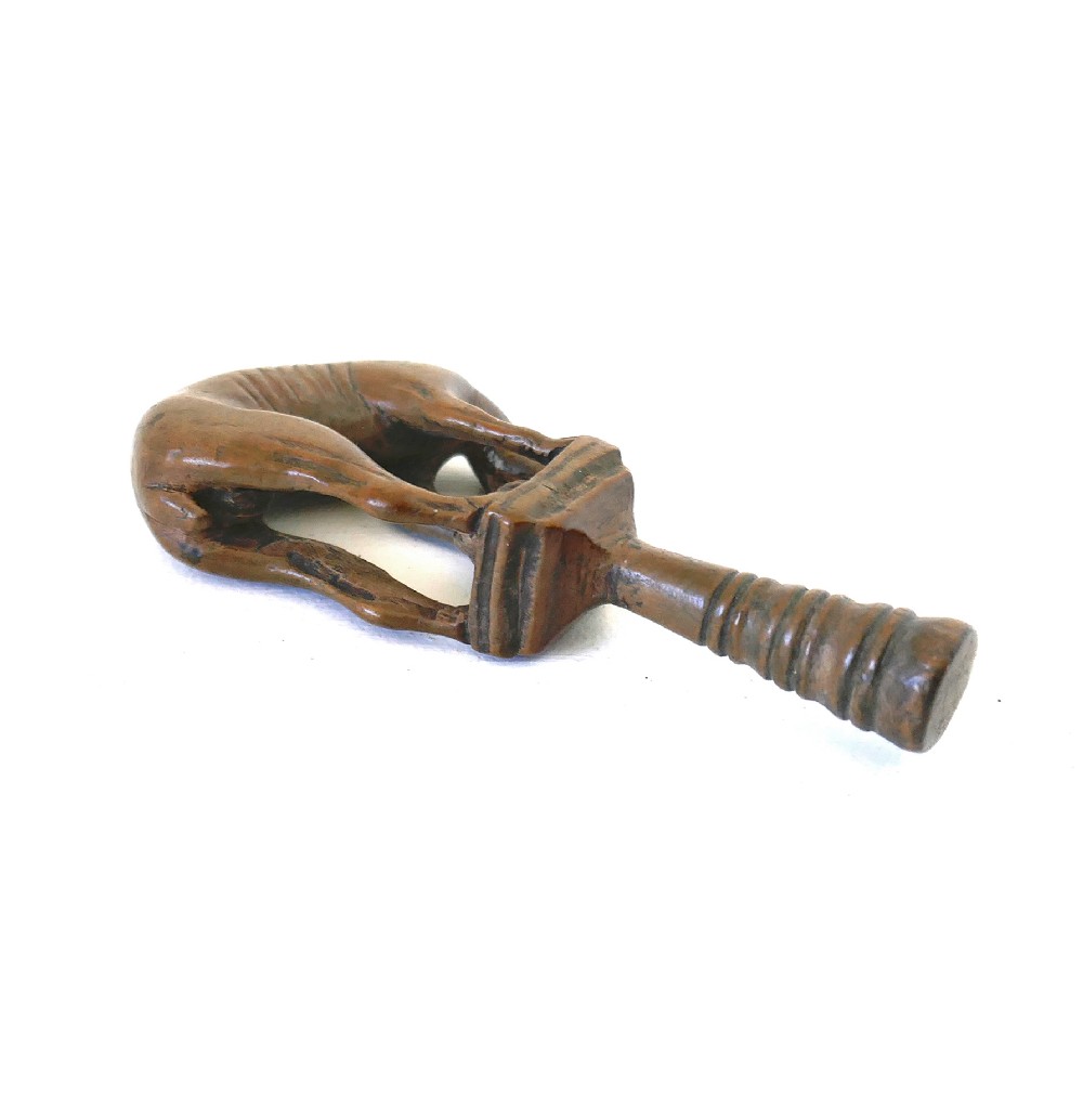 An eighteenth-century boxwood pipe tamper hand-carved in the shape of a greyhound atop a turned pedestal. View V