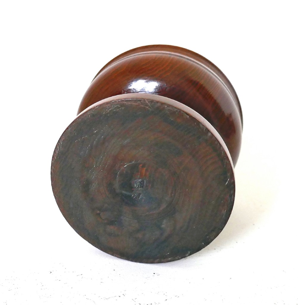 An 18th-century turned yew wood salt cellar featuring a bowl-shaped top set on a short pedestal stem and circular stepped base. View II