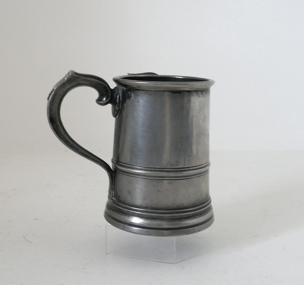 An antique 19th-century pewter ale jug featuring cursive inscription engraving, a pinched pour spout, and a moulded flared base. View III