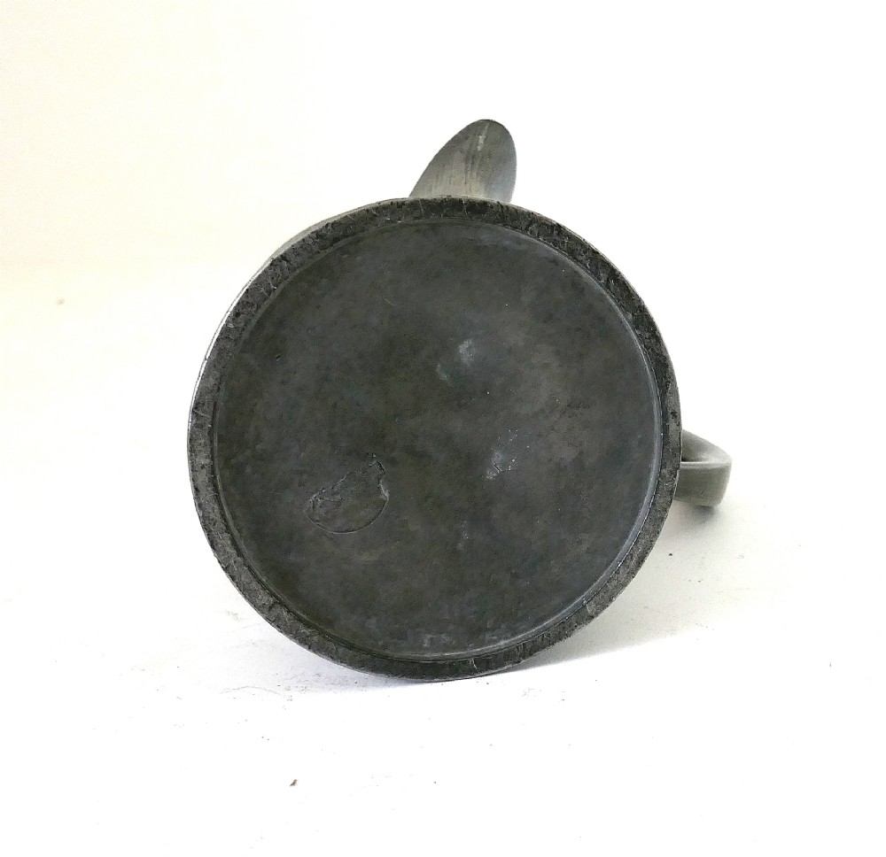 An antique 19th-century pewter ale jug featuring cursive inscription engraving, a pinched pour spout, and a moulded flared base. View V