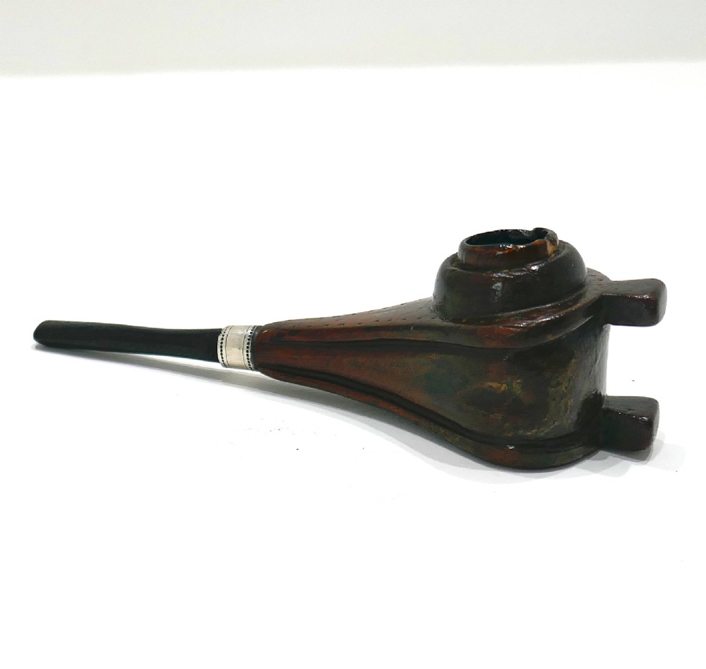 A nineteenth-century carved fruitwood tobacco pipe shaped like miniature fireplace bellows with an ebonised stem and metal ferrule band. View II