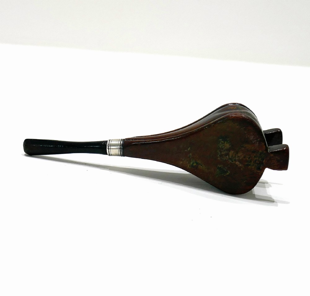 A nineteenth-century carved fruitwood tobacco pipe shaped like miniature fireplace bellows with an ebonised stem and metal ferrule band. View IV
